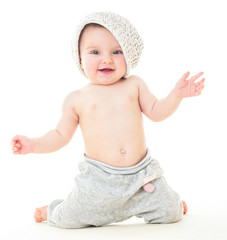 Wall Mural - Dancing baby. Сheerful baby in the hat. Beautiful happy baby .