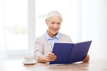 Poster - happy smiling senior woman reading book at home