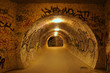 Photography of underground pedestrian passage with graffiti on the walls