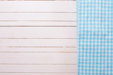 Canvas Print - Blue kitchen towel  on white wooden background.