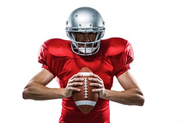 American football player in red jersey and helmet holding ball