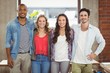 © WavebreakMediaMicro - Business people standing with arms around creative office