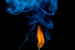 Ignition of match with smoke on black background
