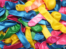 Colorful Vibrant Background Of A Pile Of Deflated Party Balloons In The Colors Of The Rainbow Or Spectrum For A Festive Occasion Or Holiday Celebration