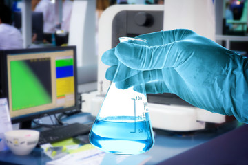 Wall Mural - flask in scientist with laboratory background