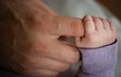 © shara - Father finger and newborn baby hand