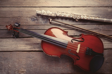 Wall Mural - Flute with violin on table close up