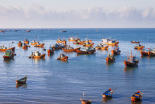 Fishing Village, Market And Colorful Traditional Fishing Boats Near Mui Ne, Binh Thuan, Vietnam. Early Morning, Fishermen Float To The Coast With A Catch.