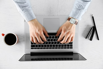 Wall Mural - Man working with laptop, top view