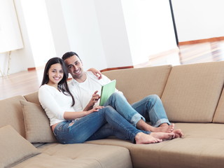 couple at modern home using tablet computer