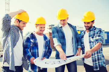 Poster - group of builders with tablet pc and blueprint