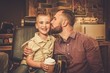 © Nejron Photo - Stylish little boy and his father in a barber shop