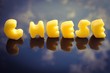 The word cheese written in cheese chunks