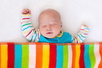 Wall Mural - little baby boy sleeping under colorful blanket