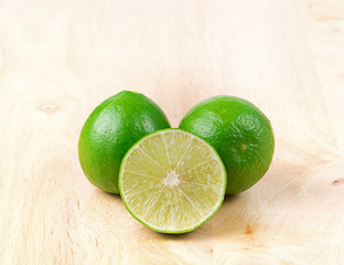 Fresh limes on wood background