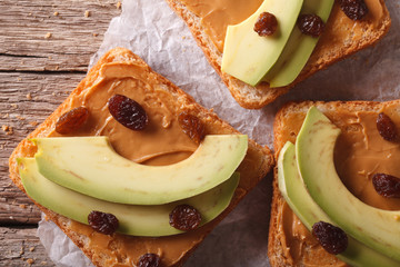 Poster - Sweet sandwiches with avocado, peanut cream macro. horizontal top view 
