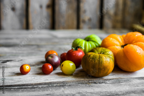 Fotografie, Obraz Colorful heirloom tomatoes on rustic wooden background