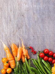 Autumn vegetables background: tomatoes, carrots, pumpkin, runner beans, chilies