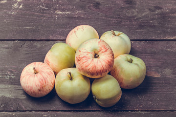 Wall Mural - Yellow-red seasonal apples on the background of old boards. Tone