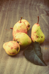 Wall Mural - Yellow seasonal pears with leaf on the background of old boards.