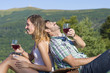 © creativefamily - Happy couple drinking wine on a hiking trip