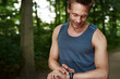 © Flamingo Images - Man Looking at his Watch While in Outdoor Training