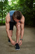 © Flamingo Images - Athletic Young Man Tying his Shoelace