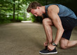 © Flamingo Images - Side View of a Fit Young Man Tying Shoelace