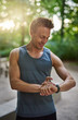 © Flamingo Images - Muscular Man Checking his Watch After his Exercise