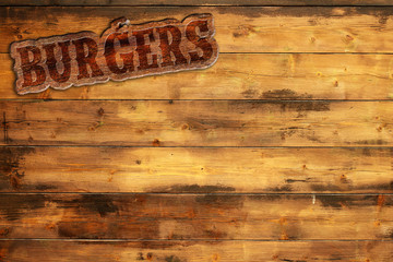 burger sign nailed to a wooden wall