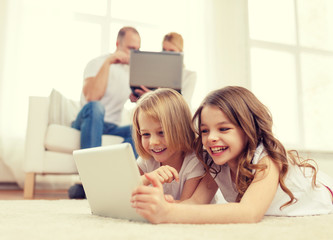 Canvas Print - smiling sister with tablet pc and parents on back