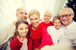 © Syda Productions - smiling family making selfie at home