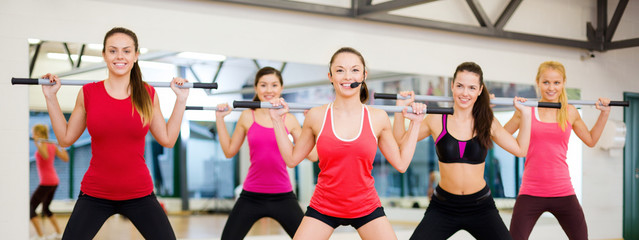 Poster - group of smiling people working out with barbells