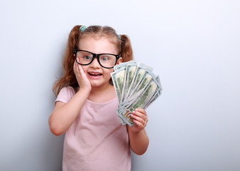 Excited kid girl earring money and thinking how spend its