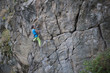 © zhukovvvlad - Young woman with rope climbs on the rock.