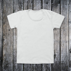 White blank t-shirt on dark wood desk