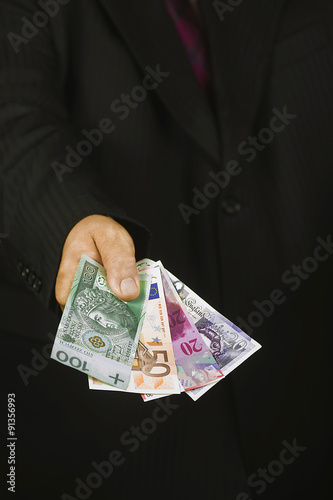 Outstretched Hand With A Banknote Euros Pounds Francs Polish Outstretched Hand With A Banknote Euros Pounds Francs Polish Zloty