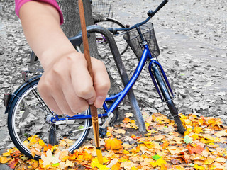 Wall Mural - paintbrush paints yellow leaves on urban street