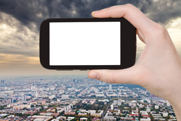 Canvas Print - smartphone and storm clouds over city