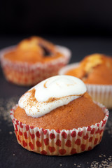 Wall Mural - Muffins with cream on dark background