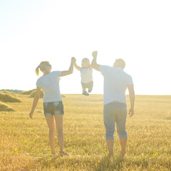 Wall Mural - happy family at sunset