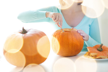 Wall Mural - close up of woman with pumpkins at home