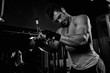 © romanolebedev - bodybuilder doing weight lifting in gym.