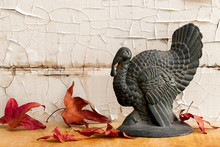 Vintage Cast Iron Turkey Turkey With Fall Leaves Against Distressed Wood