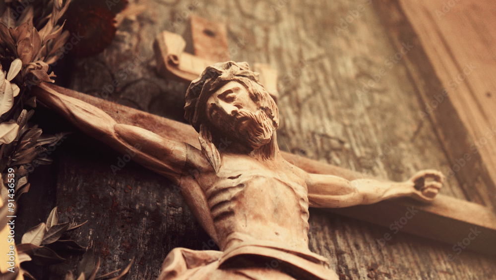 Jesus Christ crucified (an ancient wooden sculpture) - obrazy, fototapety, plakaty 