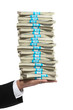 © tomsaga - Hand of a business man holding a tall stack of money