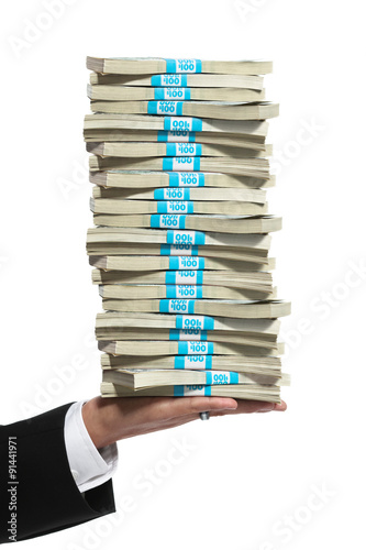 Fotografie, Obraz Hand of a business man holding a tall stack of money