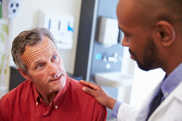 Wall Mural - Male Patient Being Reassured By Doctor In Hospital Room