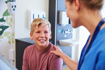 Wall Mural - Teenage Boy Being Reassured By Doctor In Hospital Room