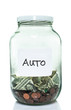 Glass jar with with a white auto label and some money in it